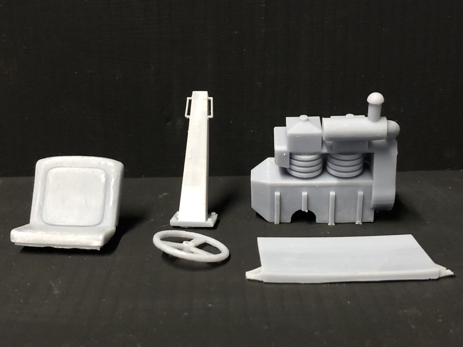 GN15 G scale narrow gauge dumper truck model kit on 16.5mm chassis, unpainted parts laid out for assembly